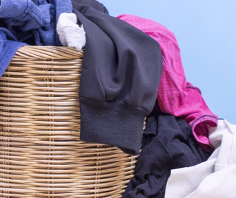 clothes in wooden basket on floor