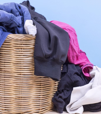 clothes in wooden basket on floor