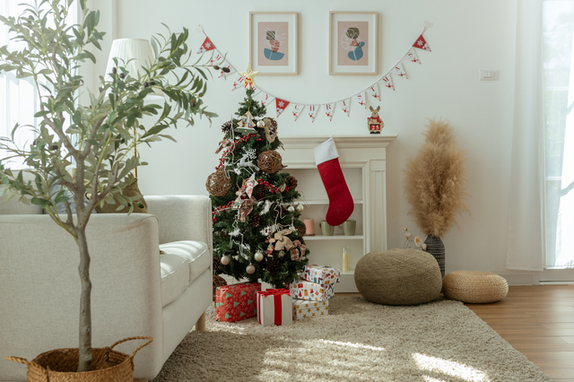 cozy holiday living room decorated with a christmas tree, gifts, and festive elements