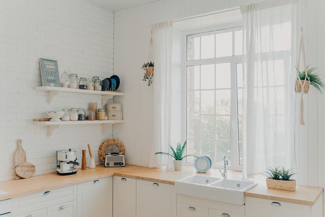 domestic family kitchen. brightly lit scandinavian kitchen interior with window. modern apartment.
