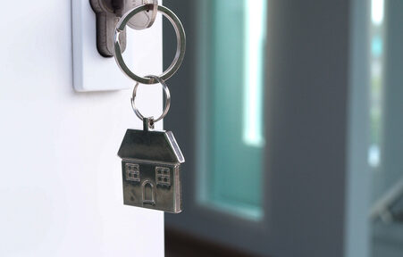 the house key for unlocking a new house is plugged into the door