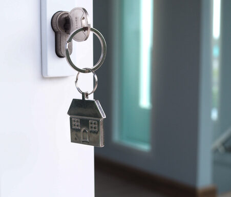 the house key for unlocking a new house is plugged into the door