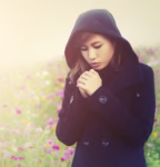 young woman wearing black cloth very cold in flower garden