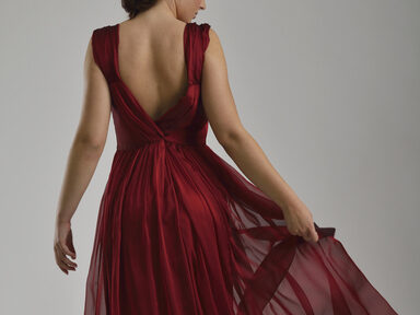 elegant woman in fashionable dress posing in the studio