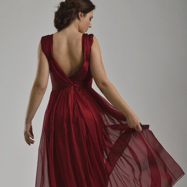 elegant woman in fashionable dress posing in the studio
